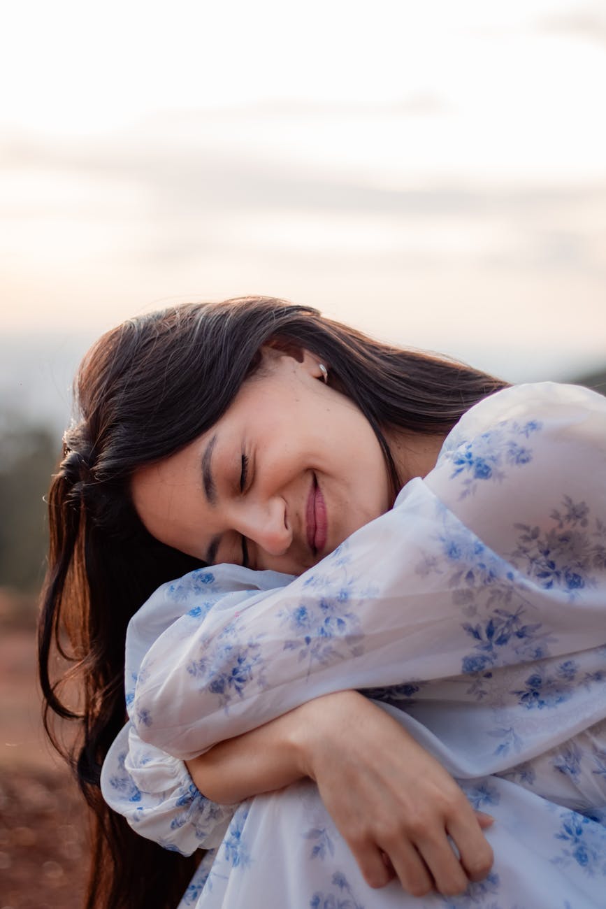 serene woman smiling outdoors at sunset