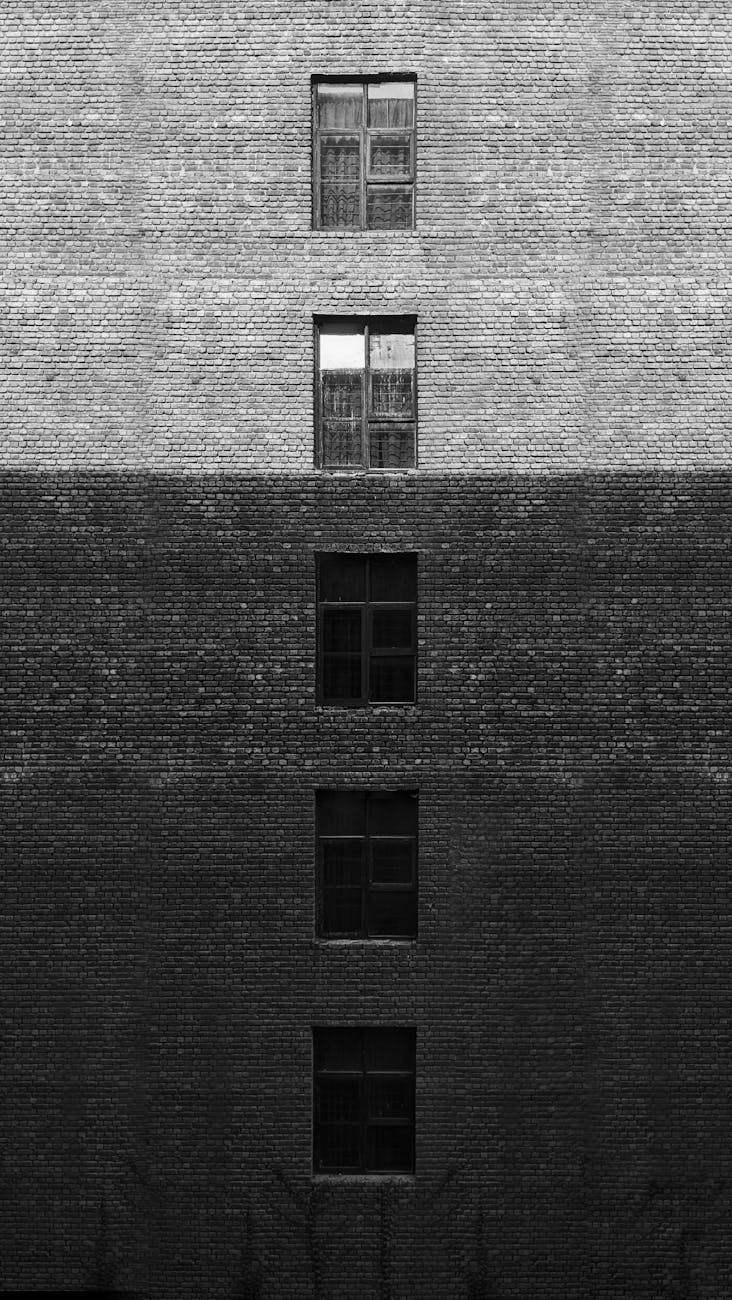 grayscale photo of a brick building