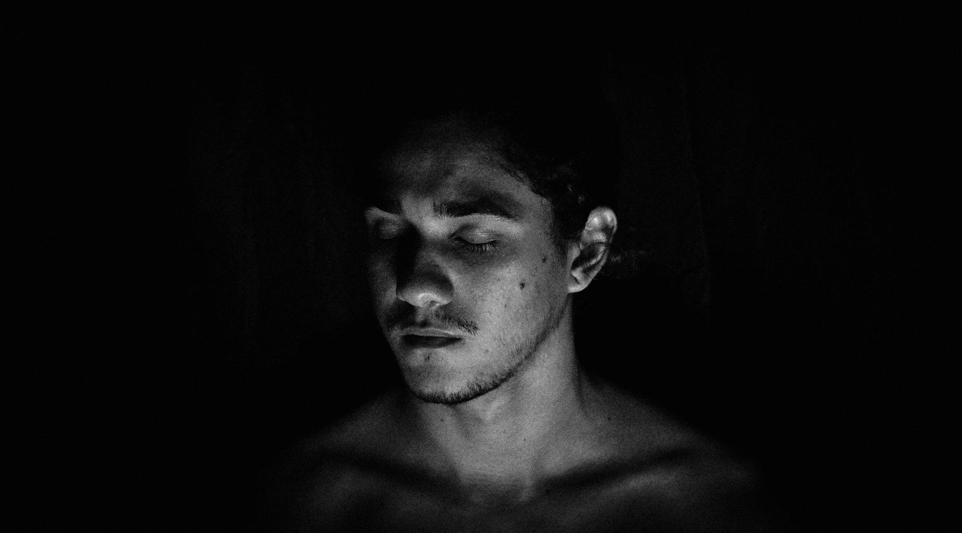 black and white portrait of a young man with his eyes closed