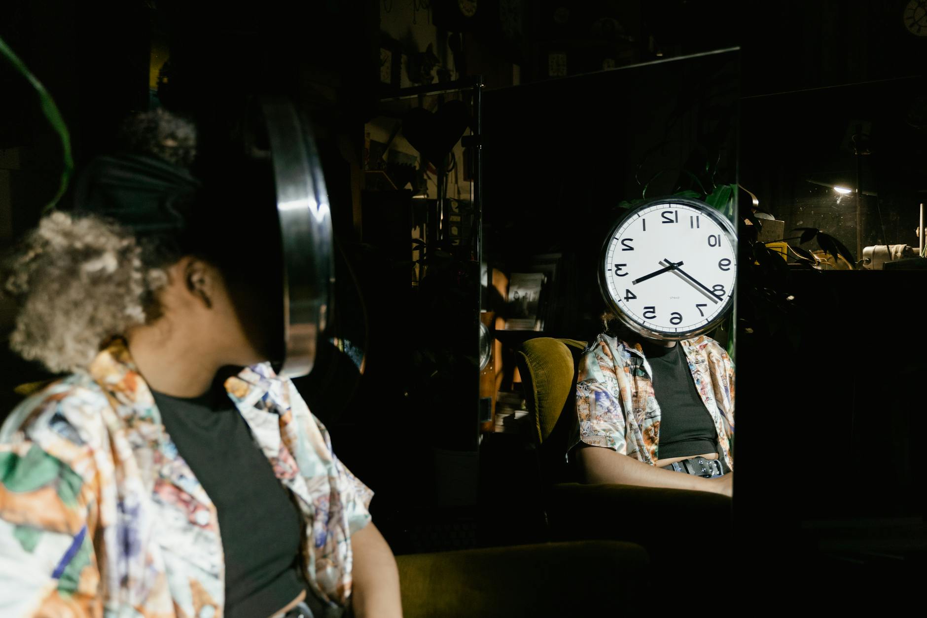 woman sitting in front of a mirror with a clock dial covering her face